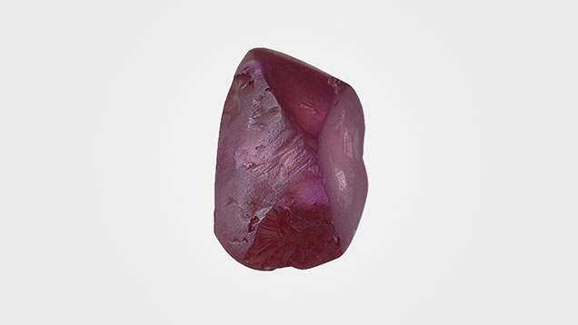 Figure 1. This 3.93 ct diamond rough was color treated to introduce its vibrant purple color. Photo by Nick “Ka Chun” Chan.