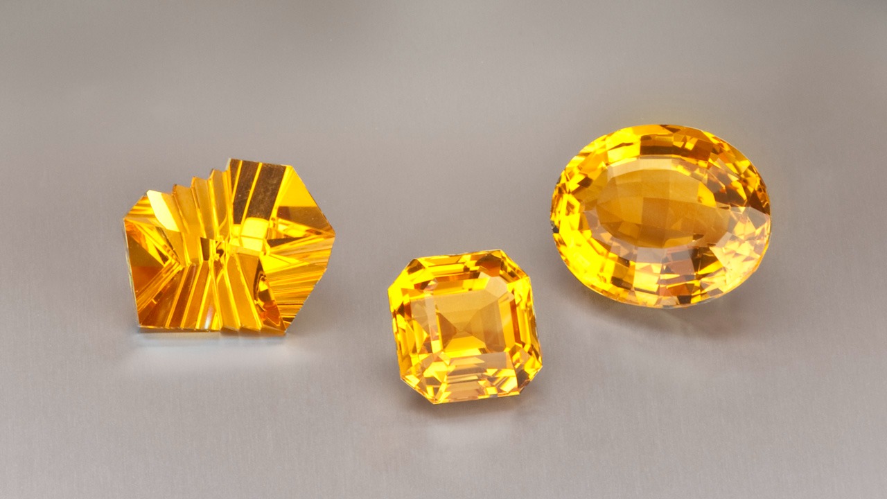 A jeweler’s display shows off citrine’s glowing shades with a designer-cut beauty alongside more traditional emerald-cut and oval gems. A jeweler’s display shows off citrine’s glowing shades with a designer-cut beauty alongside more traditional emerald-cut and oval gems.