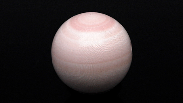 Figure 1. This round light pink bead fashioned Queen conch shell (10.20 mm and 7.50 ct) resembled a Queen conch pearl. Photo by Gaurav Bera.