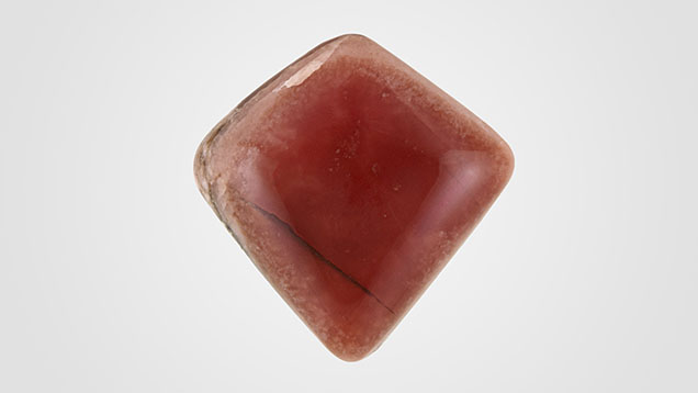 Figure 1. An orangy red translucent friedelite weighing 27.50 ct. Photo by Diego Sanchez.