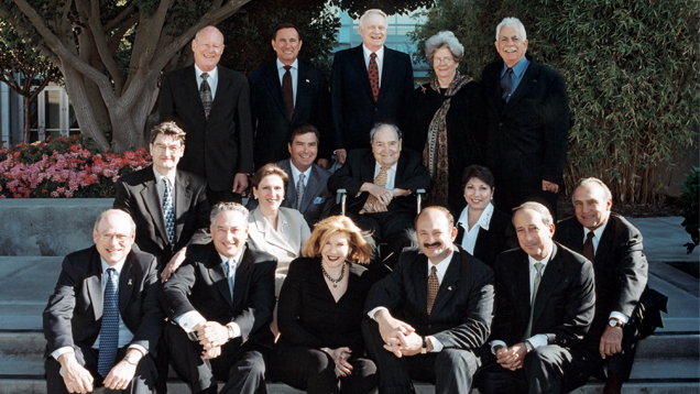 alt="The GIA Board of Governors in an undated photo with Chair Helene Fortunoff (bottom row, center). Top row, standing: William Cottingham, Ralph Destino, Glenn Nord, Nancy Brewer, Roland Naftule. Second row seated: George Rossman, Matt Stuller, Richard T. Liddicoat. Third row seated: Susan Jacques, Anna Martin, Michael Kazanjian. Front row, seated: Sheldon Kwiat, Eli Haas, Helene Fortunoff, William Boyajian and Lee Berg."