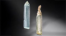 Figure 1. These aquamarine (left) and heliodor (right) crystals reported to be from China, measuring approximately 2 cm long and 0.4 cm wide, display distinctive etch pits. Photo by Adriana Robinson. Gift of Zeng Jiliang, GIA Museum nos. 20633 (left) and 20630 (right).