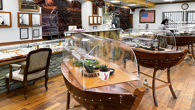Figure 1. A look inside Adamas Jewelers in San Dimas, California, operated by Chi Huynh and his brother Kiet. The store carries Galatea’s jewelry and is decorated with Huynh’s wood carvings and paintings, including the boat-style showcases inspired by the family’s journey from Vietnam. Photo by Tao Hsu.