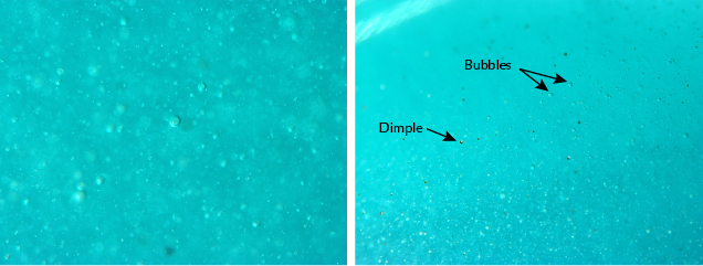 Greenish blue glass cabochon samples feature internal gas bubbles and surface dimples. 