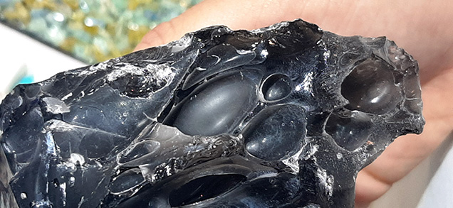 Figure 2. Detail of intact degassing bubbles in one obsidian specimen. Photo by Cristiano Brigida; courtesy of Bojo Jewelry & Minerals. Figure 2. Detail of intact degassing bubbles in one obsidian specimen. Photo by Cristiano Brigida; courtesy of Bojo Jewelry & Minerals.