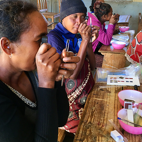 Gem testing kid given to women miners in Madagascar.
