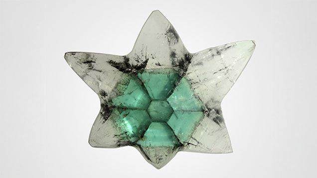 Figure 1. A 12.62 ct trapiche emerald with areas of near-colorless goshenite. Photo by Shunsuke Nagai. Figure 1. A 12.62 ct trapiche emerald with areas of near-colorless goshenite. Photo by Shunsuke Nagai.