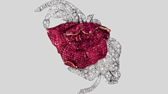 This Peony clip has petals composed of 700 Mystery-set square Burmese rubies, a heart made of six oval faceted rubies, and foliage made of 43 baguette and 196 round diamonds. The rubies weigh  60 ct total, the diamonds 30 ct. Photo courtesy of Van Cleef & Arpels.