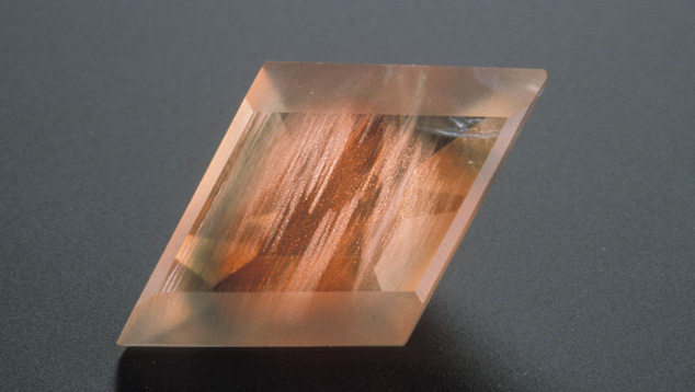 This Oregon sunstone (about 2 cm across) has been fashioned with some matte-finished facets to bring out the appearance of the copper inclusions. –  Maha Tannous, courtesy Klaus Schafer