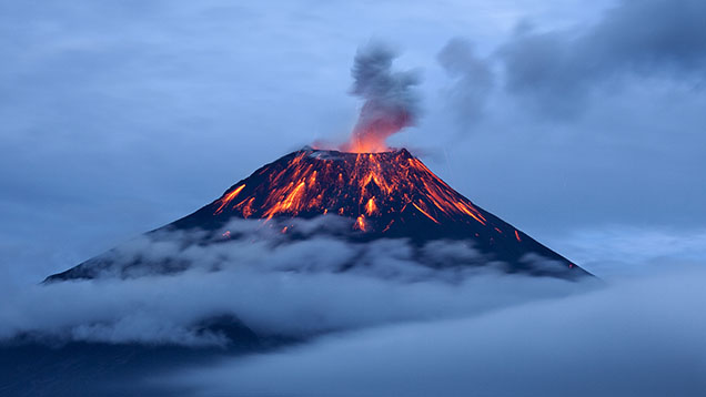 Figure 2. Eruption of the Tungurahua volcano in Ecuador. Various gem minerals can crystallize from molten magmas in the earth’s crust or when the magmas erupt at the surface. Magmas also bring up pieces of mantle or crustal rocks called <em>xenoliths</em> that are of great value for scientific study. Courtesy of Sebastián Crespo Photography/Moment/Getty Images.