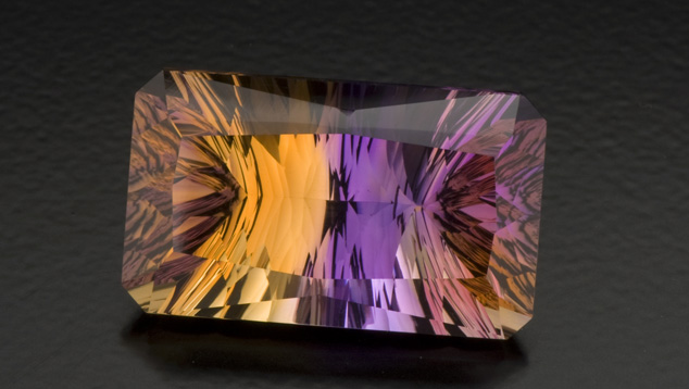 Concave facets on the pavilion contribute to the striking look of this 27.50-ct. ametrine. Creative gem cutters sometimes use concave facets to give a gem a dramatic appearance. Photo by Robert Weldon/GIA, courtesy Minerales y Metales del Oriente.