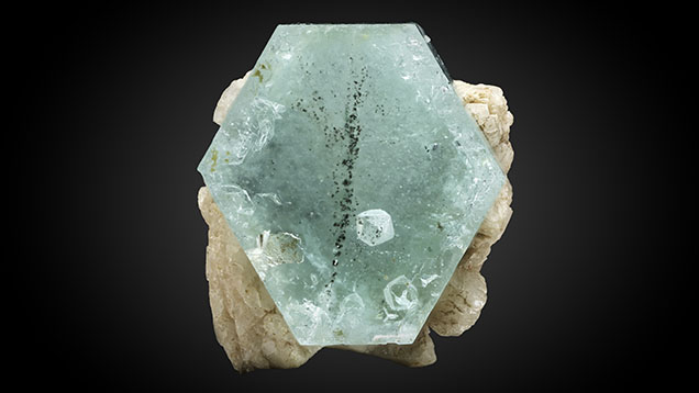 Figure 1. A sharply defined inclusion of <em>α</em>-quartz with <em>β</em>-quartz form is observed within beryl. Photo by Harold Moritz.