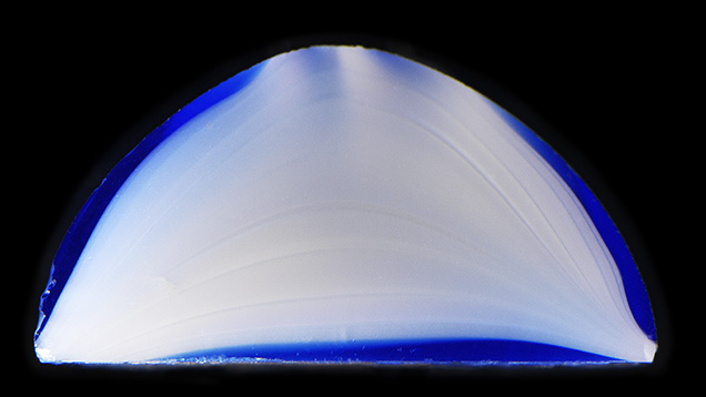 Cross section of the glass cabochon reveals flow lines.