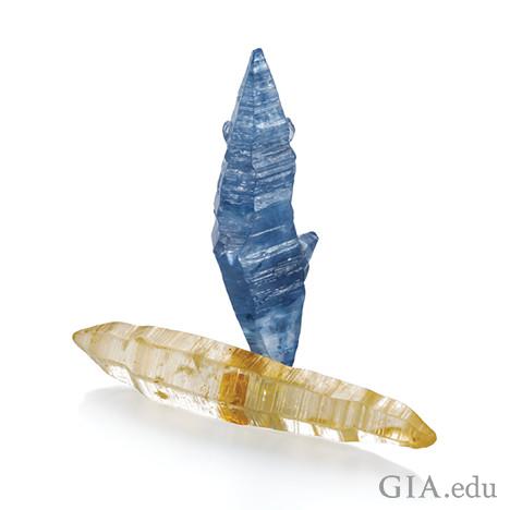 Image showing two sapphire crystals, one blue and one yellowish-white. 