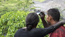 Husband and wife gaze happily at emerald rough found in a Colombian mine.