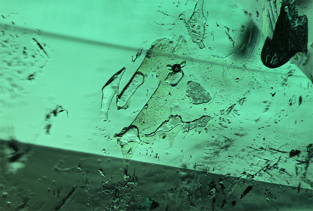 Irregularly shaped cavities in emerald. Irregularly shaped cavities in emerald.