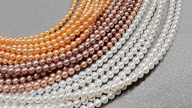 Figure 1. Near-round to round small freshwater bead cultured pearls (approximately 2–4 mm) were widely available at the AGTA show in various colors including white, pink, purple, and orange. Photo by Artitaya Homkrajae; courtesy of Betty Sue King, King’s Ransom. Figure 1. Near-round to round small freshwater bead cultured pearls (approximately 2–4 mm) were widely available at the AGTA show in various colors including white, pink, purple, and orange. Photo by Artitaya Homkrajae; courtesy of Betty Sue King, King’s Ransom.