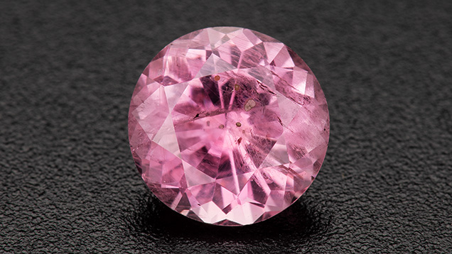 Figure 1. A 1.28 ct heated pink round brilliant sapphire. Photo by Robert Weldon; courtesy of Greenland Ruby. Figure 1. A 1.28 ct heated pink round brilliant sapphire. Photo by Robert Weldon; courtesy of Greenland Ruby.