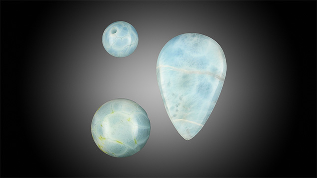 Two quench-crackled dyed chalcedony round beads resemble Larimar in appearance.