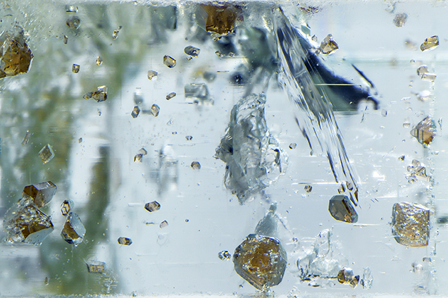 Raman identified these inclusions as spessartine. Raman identified these inclusions as spessartine.