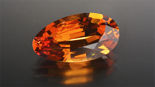 Orange pear-shaped pyrope-spessartine-grossular garnet. Orange pear-shaped pyrope-spessartine-grossular garnet.