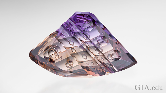 A triangular shaped carved piece of ametrine with a rounded bottom. “Bubbles” of internal carvings can be seen. A triangular shaped carved piece of ametrine with a rounded bottom. “Bubbles” of internal carvings can be seen.