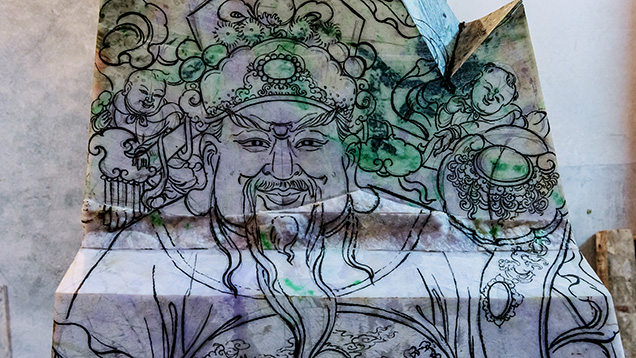 Close-up of sketch of Chinese god Lu on jadeite rough Close-up of sketch of Chinese god Lu on jadeite rough