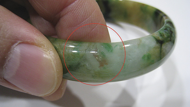 Jadeite bangle revealing natural inclusions Jadeite bangle revealing natural inclusions