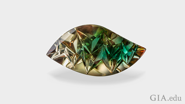 A carved wave-shaped gem with brown on the outer area and green in the center. A carved wave-shaped gem with brown on the outer area and green in the center.