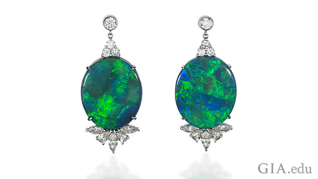 A pair of 18k white gold and black Australian opal and diamond earrings. The opal is 38.97cts. A pair of 18k white gold and black Australian opal and diamond earrings. The opal is 38.97cts.