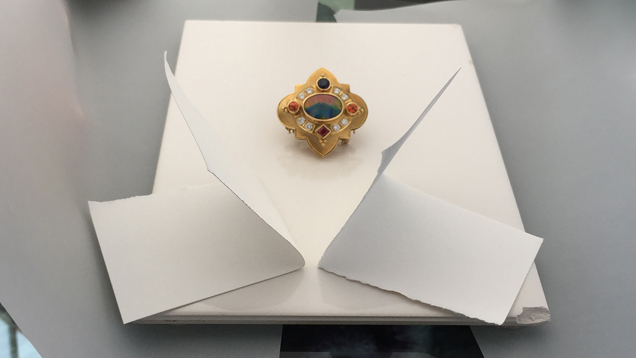 Image showing white cards bouncing light towards a jeweled brooch. Image showing white cards bouncing light towards a jeweled brooch.