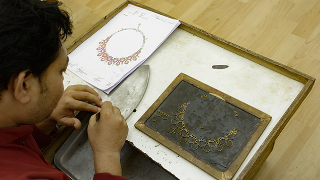 Jeweler making gold frame