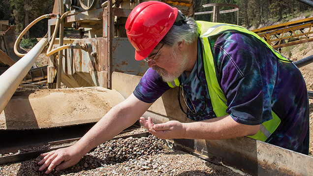 Man retrieving samples from jig