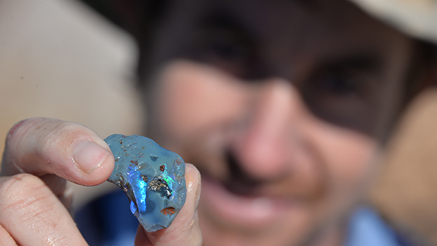 Man holding opal