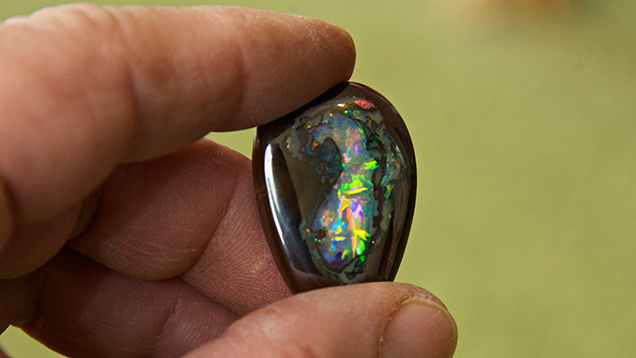 Hand holding boulder opal Hand holding boulder opal