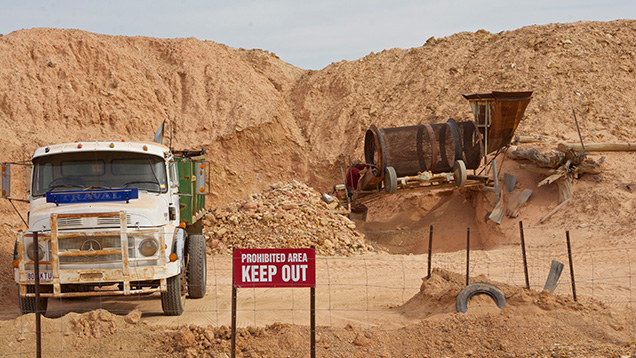 Trucks at boulder opal mining and processing site Trucks at boulder opal mining and processing site