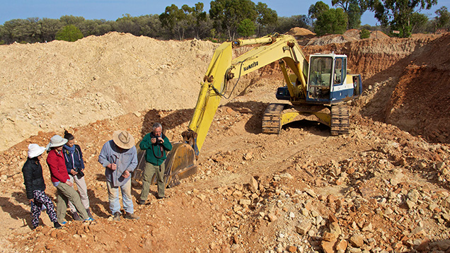Group of people in an open-pit opal mine Group of people in an open-pit opal mine
