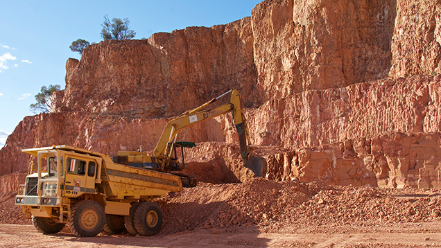 Truck and excavator working in opal mine Truck and excavator working in opal mine