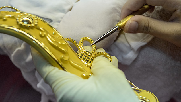 Wax carver creates intricate details for jewelry pieces Wax carver creates intricate details for jewelry pieces