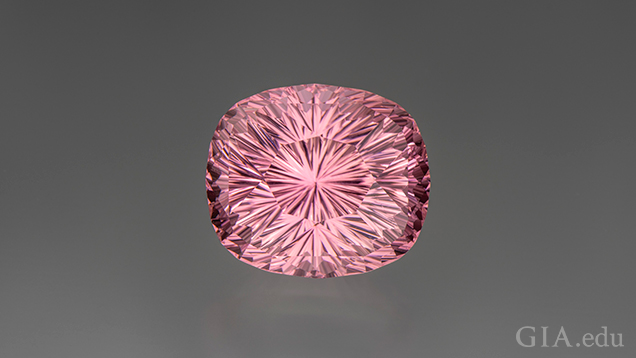 A rounded corners, rectangle-shaped piece of carved pink tourmaline. A rounded corners, rectangle-shaped piece of carved pink tourmaline.