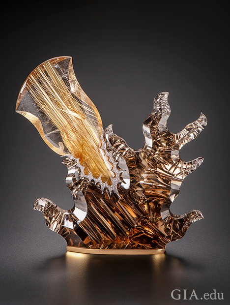 Two pieces of rutileted quartz, one light and one dark, in an abstract sculpture. Two pieces of rutileted quartz, one light and one dark, in an abstract sculpture.