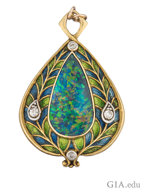 A pear shaped black opal cabochon is enhanced by European-cut diamonds and blue and green enamel applied on 14k gold gold. A pear shaped black opal cabochon is enhanced by European-cut diamonds and blue and green enamel applied on 14k gold gold.