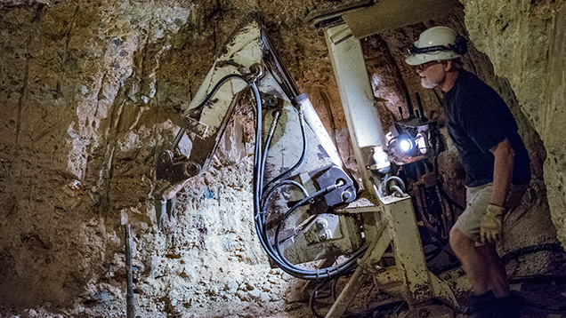 Man using digger underground