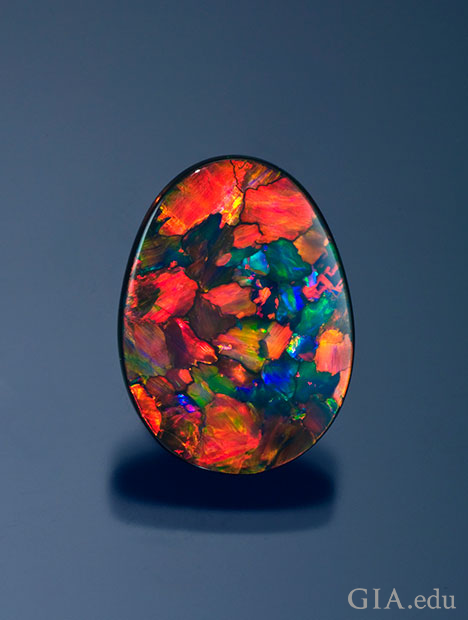 A 13.60 ct. black opal from Lightning Ridge, Australia shows off the orange, red, blue and green colors it is known for. A 13.60 ct. black opal from Lightning Ridge, Australia shows off the orange, red, blue and green colors it is known for.