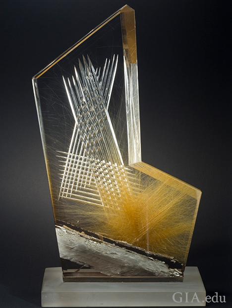 A piece of quartz with inclusions carved in x patterns. A piece of quartz with inclusions carved in x patterns.