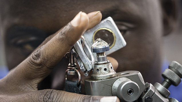 Laurelton employee examining a diamond Laurelton employee examining a diamond