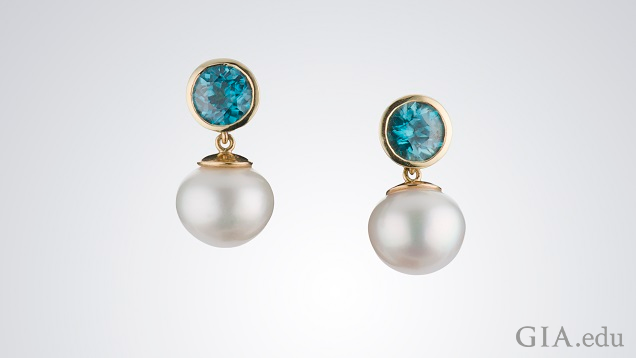 White pearls drop from round bezel set blue zircon. White pearls drop from round bezel set blue zircon.