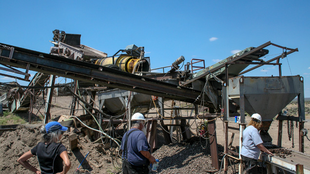 In this view of the mine’s processing plant, the shaker at top left is feeding ore into the yellow cylindrical trommel. Concentrate can either be directed to the hopper and belt in the foreground or to the optical sorting machine via the conveyor running diagonally to the left. - Duncan Pay In this view of the mine’s processing plant, the shaker at top left is feeding ore into the yellow cylindrical trommel. Concentrate can either be directed to the hopper and belt in the foreground or to the optical sorting machine via the conveyor running diagonally to the left. - Duncan Pay