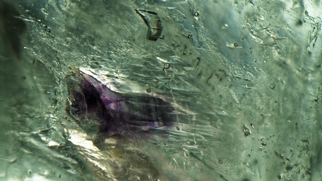 Distinct purple banding in a fluorite inclusion in emerald Distinct purple banding in a fluorite inclusion in emerald