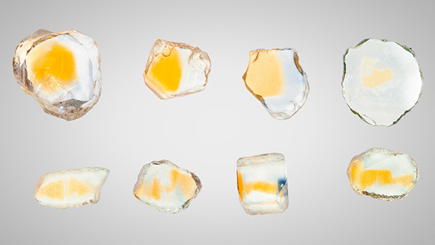 Figure 13. Sapphires from Rock Creek, Montana. The wafers in the top row are cut perpendicular to the c-axis and the wafers in the bottom row are cut parallel to the c-axis. These stones have been heat treated at 1200°C in oxygen. Photo by John L. Emmett. Figure 13. Sapphires from Rock Creek, Montana. The wafers in the top row are cut perpendicular to the c-axis and the wafers in the bottom row are cut parallel to the c-axis. These stones have been heat treated at 1200°C in oxygen. Photo by John L. Emmett.